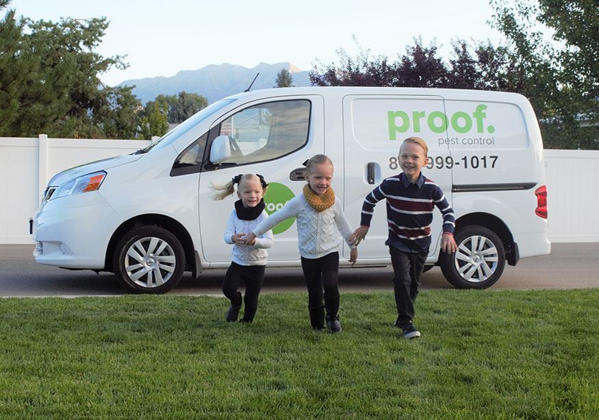 Kids running in front of a proof. truck
