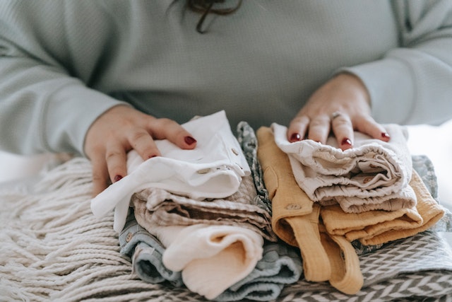 Woman folding a clothing and towels