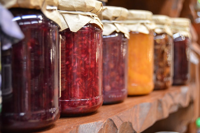 Multicolored canned goods lined up in a row