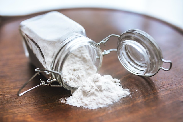 White baking soda falling out of a bottle