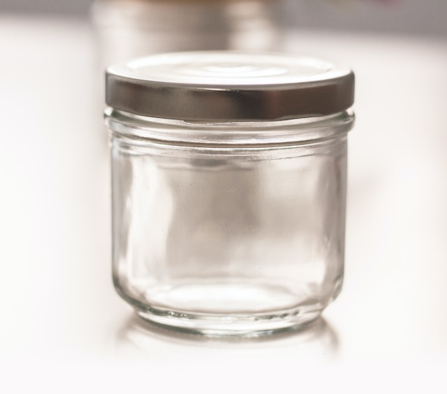 Empty jar with a silver lid, one of the pet-safe ant traps