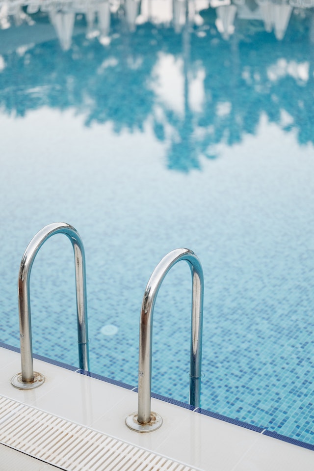 Blue poolside with a ladder