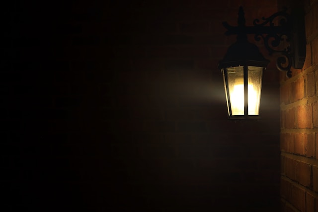 Lone yellow porch light at night