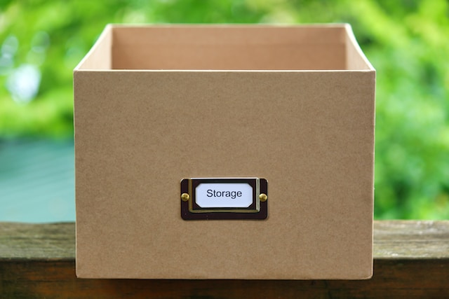 Brown storage box that says "storage" on a brown board