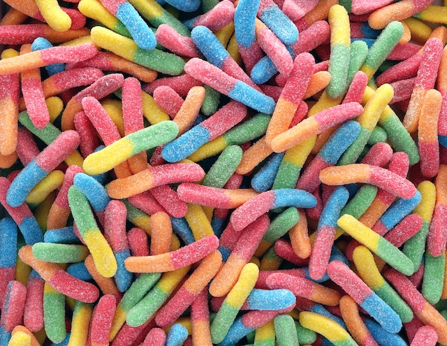 Multi-colored gummy worms with sugar, an excellent silverfish bait