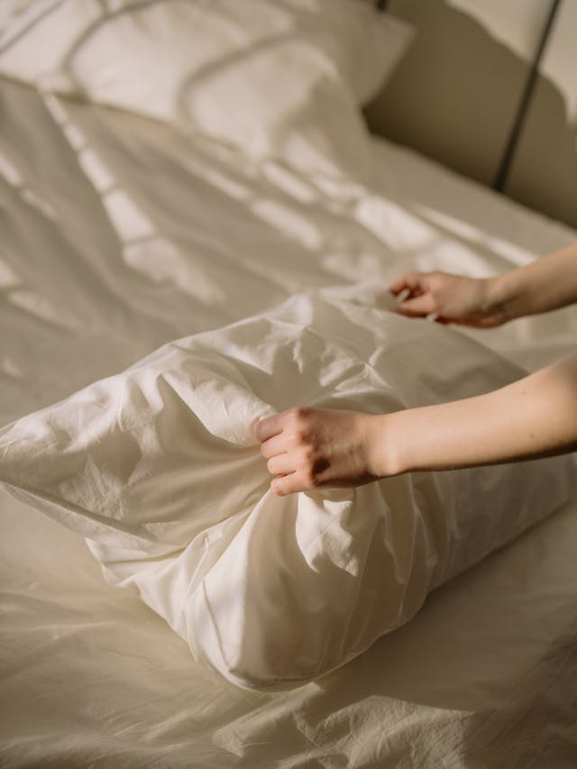 Person replacing a pillow case